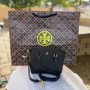 The color is the black brand is Tory burch the size is OS is leather